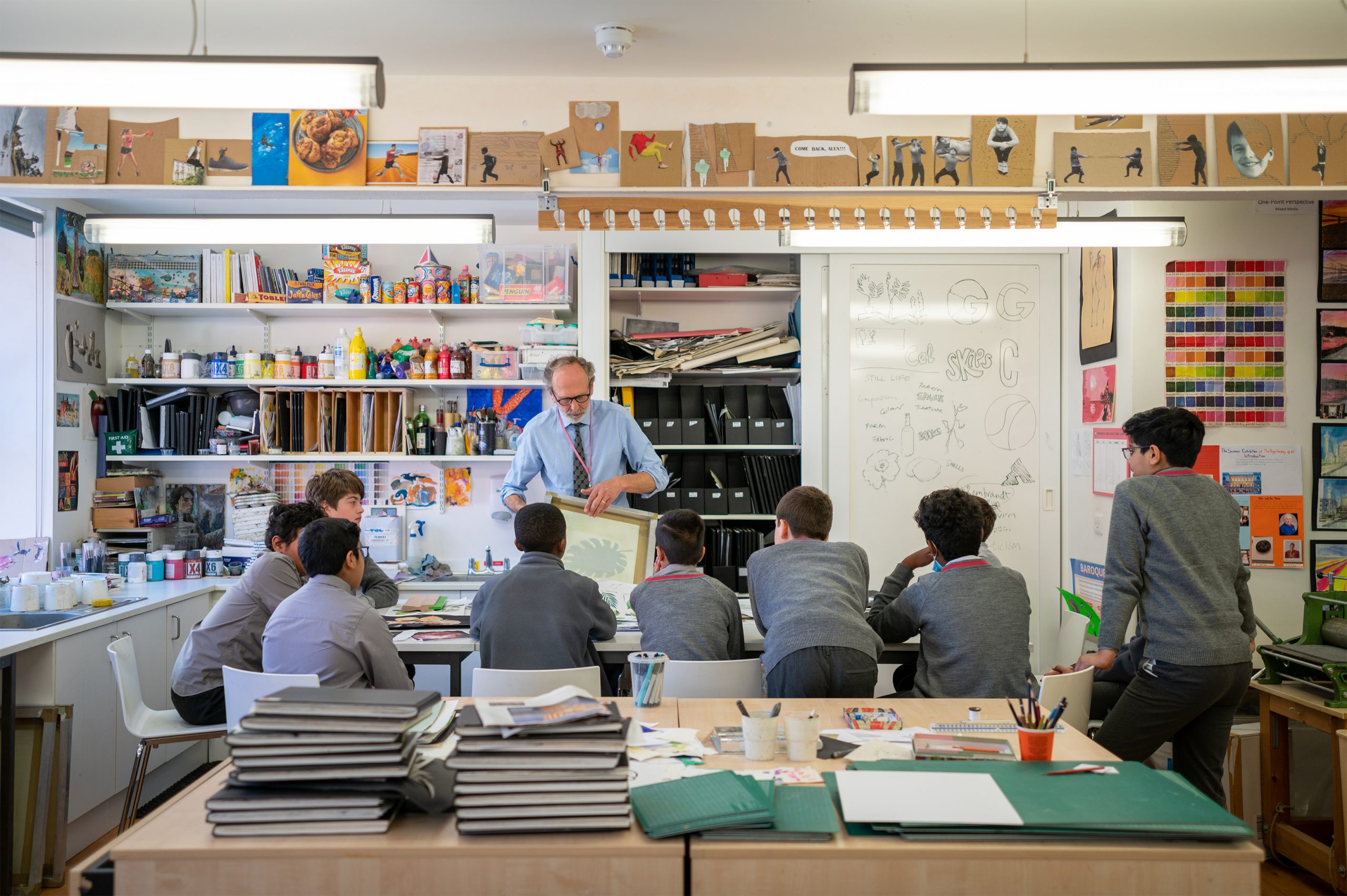 Art teacher teaching pupils in the art studio