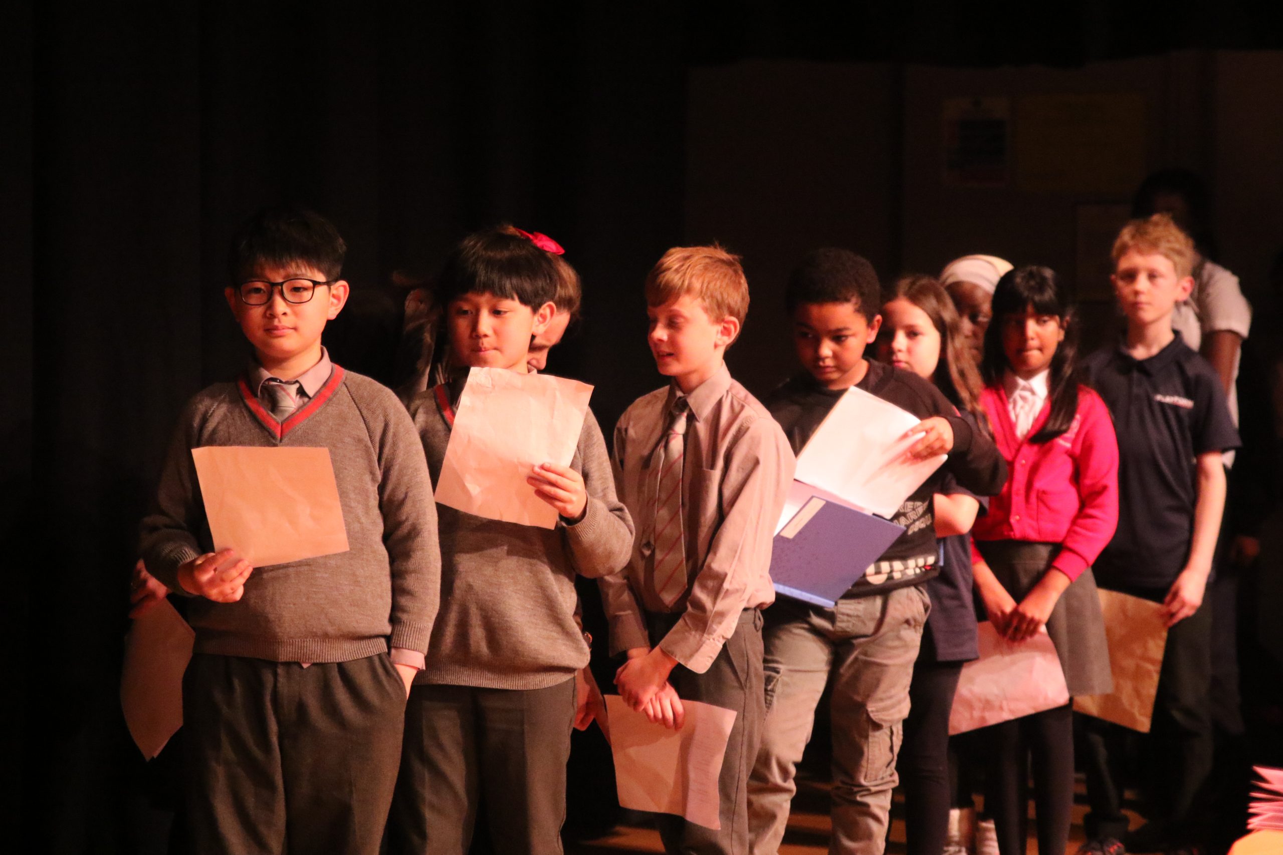 WUS and Platform pupils lined up waiting to perform poetry on stage