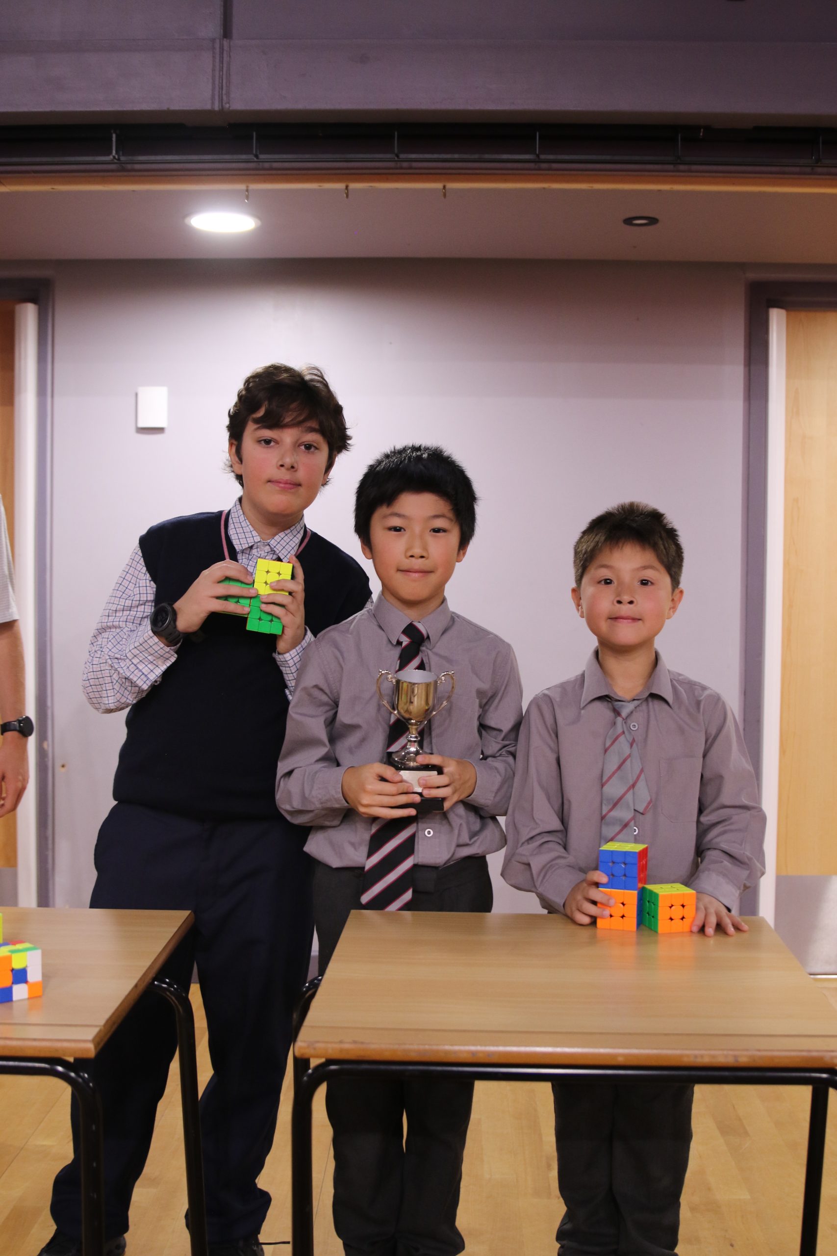 Finalists in the WUS Speedcubing Competition with the winner holding the trophy.